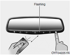 Hyundai Santa Fe: Programming. 2. Position the end of your hand-held transmitter 1-3 inches (2-8 cm) away from