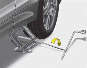 Hyundai Santa Fe: Changing tires. 8. Insert the jack handle into the jack and turn it clockwise, raising the vehicle