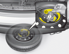 Hyundai Santa Fe: Removing and storing the spare tire. 5. After the spare tire reaches the ground, continue to turn the wrench counterclockwise,